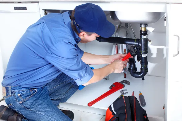 a male plumber fixing a toilet from quality plumbing leander in Leander, TX  Plumber near me